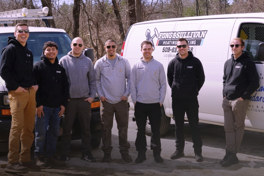 The Fong & Sullivan HVAC team in front of company vans